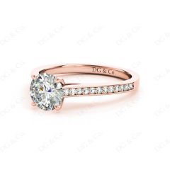 Round Cut Four Claw Set Diamond Ring with Round Cut Channel Diamonds Down the Shoulders and on the Setting in 18K Rose