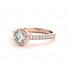 Round Cut Bezel Diamond Ring with Channel Set Side Stones in 18K Rose