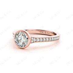 Round Cut Bezel Set Diamond Ring with Channel Set Diamonds Down the Shoulders in 18K Rose