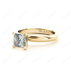 Princess Cut Classic Four Claw Diamond Solitaire Ring with Half Round Edge Shoulders in 18K Yellow