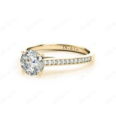 Round Cut Four Claw Set Diamond Ring with Round Cut Channel Diamonds Down the Shoulders and on the Setting in 18K Yellow