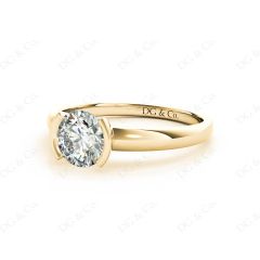 Round Cut Bezel Set Diamond Ring on a Plain Band. in 18K Yellow